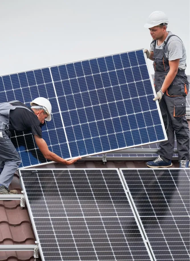 two people holding solar on roof